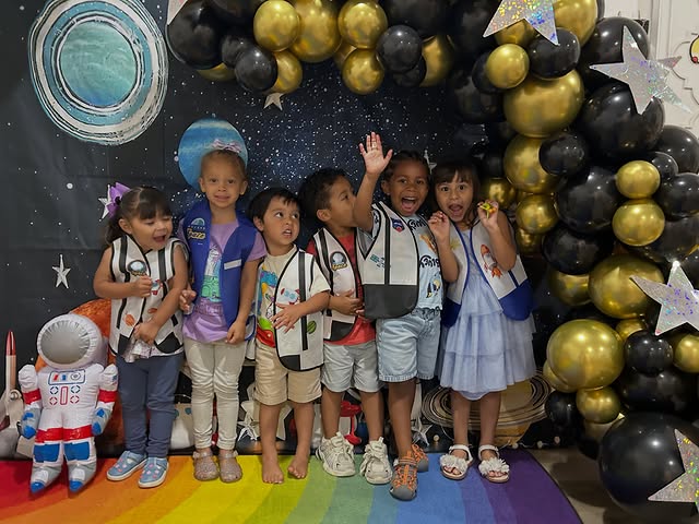 Children celebrating at the space-themed summer camp party